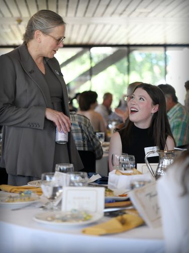 NG体育 President Dr. Kelly Ryan speaking with a student. 